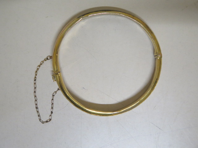A hallmarked 9ct yellow gold bangle - 5.3cm x 5.5cm external - approx weight 7.2 grams - some - Image 2 of 2