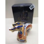 A Royal Crown Derby paperweight of a dragon - boxed and in mint condition