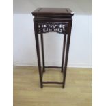 A Chinese hardwood jardiniere/plant stand with fretwork frieze - Height 92cm x 31cm x 31cm - in