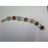 A 9ct yellow gold semi precious seven stone bracelet - Length 18.5cm - approx weight 21 grams - in