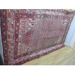 A hand knotted woollen Araak rug - 2.05m x 1.22m