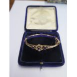 A 9ct yellow gold amethyst and pearl hinged bangle - 6.5cm x 5.5cm external - approx weight 6.6