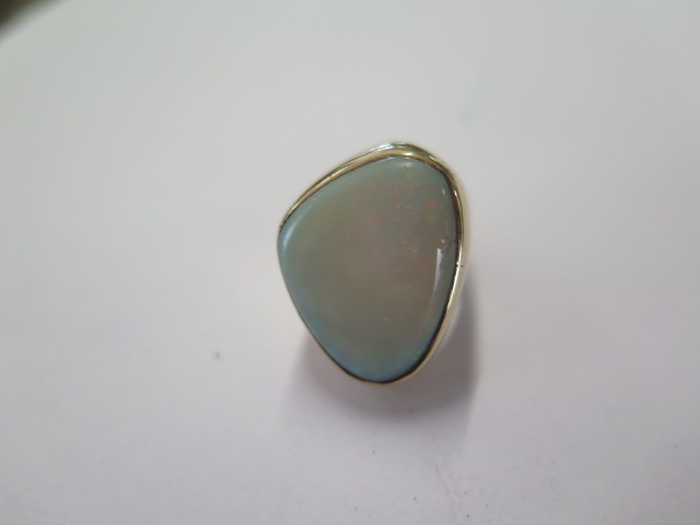 A gilt metal opal ring size H/I - head approx 25mm x 20mm - surface tests to approx 9ct gold -