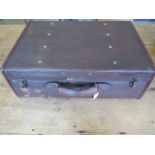 A vintage fibre leather bound suitcase with brass fittings - 19cm x 55cm x 38cm - in polished