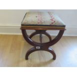 A good quality footstool with a needlepoint top