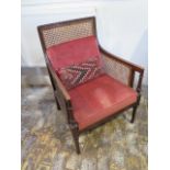 An early 1900's mahogany Bergère armchair - Height 86cm x Width 59cm - with drop in upholstered seat