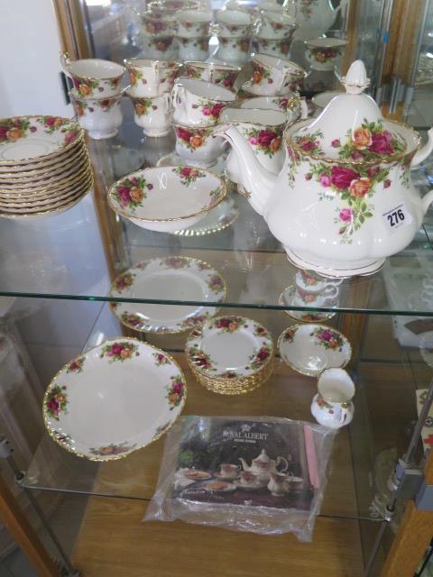 A Royal Albert Country Rose tea set - tea pot, milk jug, sugar basin, a cake plate, nine cups,