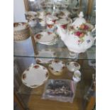 A Royal Albert Country Rose tea set - tea pot, milk jug, sugar basin, a cake plate, nine cups,