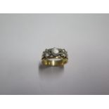 A gold three stone diamond ring size M/N - centre stone approx 0.50ct - tests to approx 18ct -