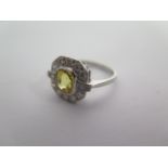 An Art Deco Style Yellow Sapphire (Good Colour) Ring set in Platinum , Surrounded by 14 Round Brilli
