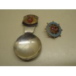 A Queen Mary enamel ships wheel badge and a caddy spoon