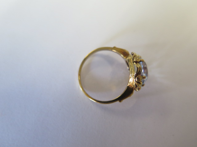 A yellow metal dress ring set with a round 10mm synthetic blue spinel claw set within a looped - Image 3 of 3