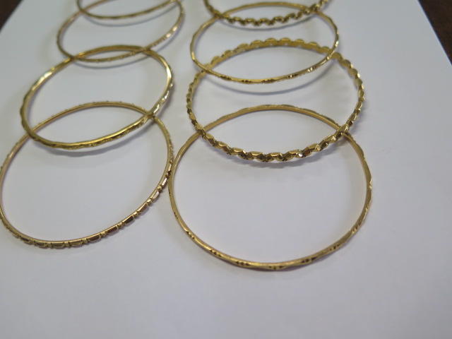 Eleven yellow metal bangles - surface test to approx 18ct gold - 6.2cm external diameter - total - Image 4 of 4