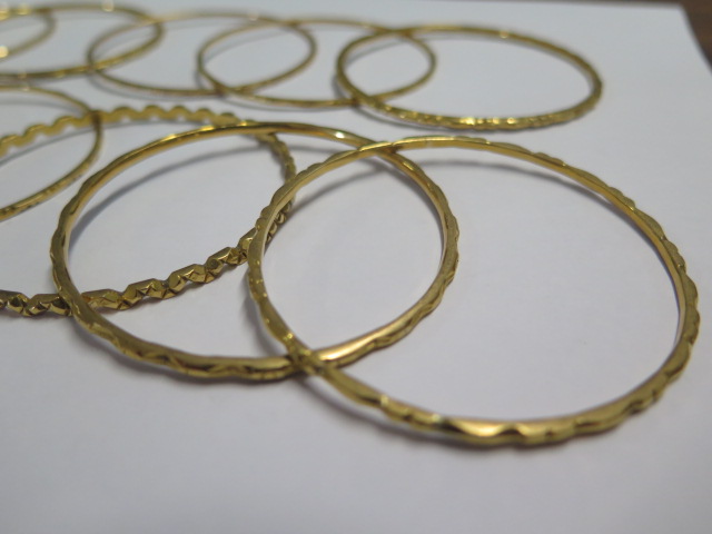 Eleven yellow metal bangles - surface test to approx 18ct gold - 6.2cm external diameter - total - Image 2 of 4