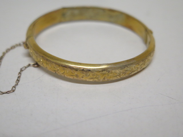 A hallmarked 9ct yellow gold bangle - 5.3cm x 5.5cm external - approx weight 7.2 grams - some