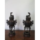 A pair of Oriental bronze lidded censors on stands - Height 41cm - both with good patina