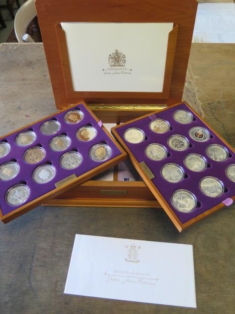 A Royal Mint Queen Elizabeth II Golden Jubilee collection - 24 silver coins in a wood effect