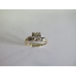 A 14ct yellow and white metal three stone diamond ring size M/N - approx weight 2 grams -