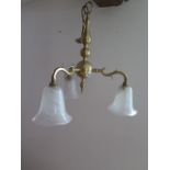 A brass three branch ceiling light with bell shaped glass shades - Width 53cm