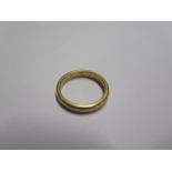 A hallmarked 22ct yellow gold band ring size N - approx weight 5.7 grams - engraved to inside of