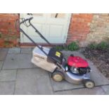 A Honda 12y petrol driven 18" cut self propelled lawnmower with easy start auto choke