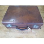 A vintage leather suitcase with interesting travel stickers - 17cm x 51cm x 38cm - with good colour,