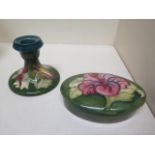 A Moorcroft green ground lidded pot - Width 13cm and a Moorcroft green ground candlestick - Height