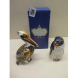 A Royal Crown Derby paperweight of a pelican and a boxed penguin both very good condition