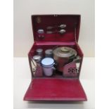A tan leather en route/motoring/travel/tea/picnic case with a kettle and a burner, milk and sugar