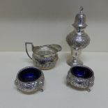 An embossed silver caster, a jug - total approx weight 11 troy oz and a pair of embossed silver