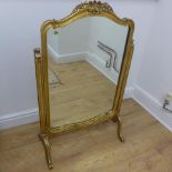 A gilt dressing table mirror on an ornate frame - Height 98cm x Width 62cm