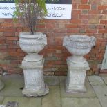 A pair of garden urns on stands - Height 100cm