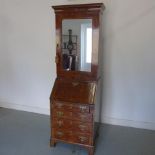A good quality burr walnut slim bureau bookcase with a mirror door with shelves over the base with a