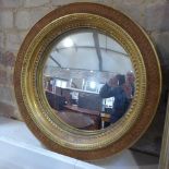 A 19th century wooden gilt circular mirror with convex glass - Diameter 46cm