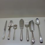 A selection of seven silver and silver handle servers including asparagus tongs and a 30cm serving