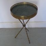 A brass side table with a granite inset top on three legs - Diameter 30cm x Height 50cm