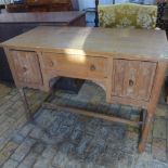 A limed oak desk/dressing table with linen fold carved doors - Width 107cm x Height 77cm