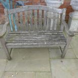 A weathered teak garden bench - Width 130cm