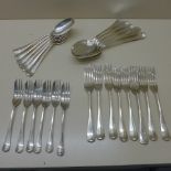 Two sets of six silver spoons, eight silver forks and six silver cake forks, all except two forks