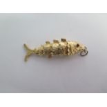 A hallmarked 9ct yellow gold articulated fish pendant - Length 6cm - approx weight 18 grams - good