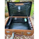 An Antique tan leather Drew & Sons of Piccadilly traveling suitcase with dark green leather interior