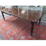 A 19th century mahogany dining table with two leaves on turned legs - 240cm x 112cm extended,