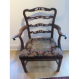 A Georgian mahogany armchair with outswept arms on square legs - in sound condition with a nice