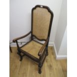 A walnut armchair with a cane seat and back