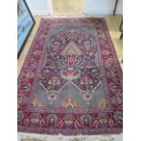 A fine Persian rug with a red field - 220cm x 135cm - in good condition