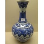 An antique Chinese blue and white vase with old staple repairs to the neck - Height 40cm