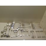 A collection of assorted silver flatware forks and spoons and a pair of nips including four GA forks