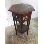 A circa 1900's carved mahogany hexagonal two tier lamp table with fretwork frieze in the Morrish