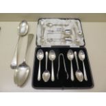 A boxed set of silver tea spoons and a nip, a pair of silver table spoons, two other sets of four