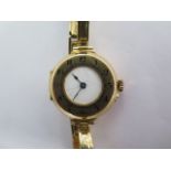 An 18ct yellow gold manual wind ladies wristwatch on 18ct sprung strap - running - approx weight